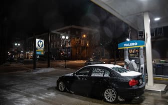 A man fuels up at a Valero in downtown Athens.
A large snow storm sweeps through the Midwest starting early Monday morning February 15, 2021 and is predicted to continue through Tuesday February 16, 2021. (Photo by Stephen Zenner / SOPA Images/Sipa USA)