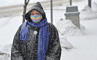 Feb 15, 2021; Girard, PA, USA; Girard, Pa., resident Diane Phelps, 54, walks along Main Street in Girard during a morning snowfall on Feb. 15, 2021. A storm expected in northwest Pennsylvania and western New York region is predicted to drop up to 15 inches of snow by Tuesday afternoon. Mandatory Credit: Christopher Millette-USA TODAY NETWORK /Sipa USA
