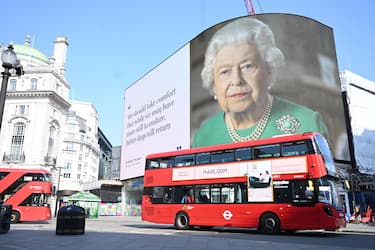 epa08352467 Britain's Queen Elizabeth and her message of hope are displayed on advertising boards at Piccadilly Circus in London, Britain, 09 April 2020. Countries around the world are taking increased measures to stem the widespread of the SARS-CoV-2 coronavirus which causes the Covid-19 disease.  EPA/NEIL HALL
