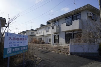 Abandoned houses at a former evacuation zone in Namie, Fukushima Prefecture, Japan, on Sunday, March 7, 2021. Laid waste by a nuclear disaster a decade ago, Japans Fukushima is still struggling to recover, even as the government tries to bring people and jobs back to former ghost towns by pouring in billions of dollars to decontaminate and rebuild. Photographer: Toru Hanai/Bloomberg via Getty Images
