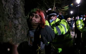 LONDON, ENGLAND - MARCH 13: A woman is arrested during a vigil for Sarah Everard on Clapham Common on March 13, 2021 in London, United Kingdom. Vigils are being held across the United Kingdom in memory of Sarah Everard. Yesterday, the Police confirmed that the remains of Ms Everard were found in a woodland area in Ashford, a week after she went missing as she walked home from visiting a friend in Clapham. Metropolitan Police Officer Wayne Couzens has been charged with her kidnap and murder. (Photo by Hollie Adams/Getty Images)
