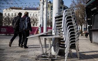 Chains secure tables and chairs outside a closed bar in Budapest, Hungary, on Tuesday, March 9, 2021. Prime Minister Viktor Orban severely tightened curbs, closing schools and nearly all retail outlets from Monday. Photographer: Akos Stiller/Bloomberg