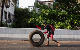 An anti-military coup protester rolls a tire during a demonstration against the military coup.
Myanmar police attacked protesters with rubber bullets, live ammunition, tear gas and stun bombs in response to anti military coup protesters on Tuesday, killing protesters and injured many others. Myanmar's military detained State Counsellor of Myanmar Aung San Suu Kyi on February 01, 2021 and declared a state of emergency while seizing the power in the country for a year after losing the election against the National League for Democracy (NLD). (Photo by Aung Kyaw Htet / SOPA Images/Sipa USA)