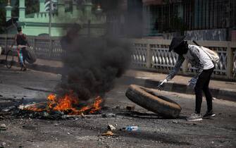 A resident burning tyres to prevent police access following Myanmar military announcing a martial law for six townships in Yangon and attacked residents and protesters with rubber bullets, live ammunition, tear gas and stun bombs in response to anti military coup protesters. The death toll since military coup rises to 189. (Photo by Theint Mon Soe / SOPA Images/Sipa USA)