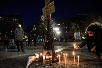 NEW YORK, NY - MARCH 19: A person lights candles during a peace vigil to honor victims of attacks on Asians on March 19, 2021 in Union Square Park in New York City. On March 16th, eight people were killed at three Atlanta-area spas, six of whom were Asian women, in an attack that sent terror through the Asian community. (Photo by Stephanie Keith/Getty Images)