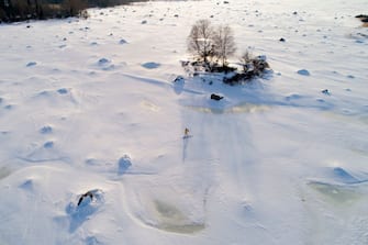 TOPSHOT - An aerial view shows a man country-skiing in Sundom aerea, near Vaasa, in the middle of the archipelago UNESCO classified, on the frozen Bothnia sea (Baltic Sea), on March 23, 2018.
In the just released 2018 UN World Happiness Report, Finland took the top spot followed by its Scandinavian neighbours and Switzerland, the Netherlands, Canada, New Zealand. / AFP PHOTO / Olivier MORIN        (Photo credit should read OLIVIER MORIN/AFP via Getty Images)