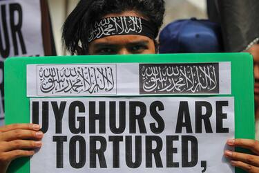 epa08091582 A demonstrator holds a placard during a protest against China's alleged abuse of the Muslim Uighur community in Xinjiang province, near the Chinese embassy in Kuala Lumpur, Malaysia, 27 December 2019. Hundreds of protesters voiced their anger at the so called 're-education camps' and 'normalization' of Uighurs and other Turkic minorities in China.  EPA/FAZRY ISMAIL