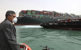 epa09095794 A handout photo made available by the Suez Canal Authority, shows the head of the Suez Canal Authority Lt. Gen. Ossama Rabei (L) assessing the situation near the Ever Given container ship and a tugboat, in the Suez Canal, Egypt, 25 March 2021. The Ever Given, a large container ship ran aground in the Suez Canal on 23 March, blocking passage of other ships and causing a traffic jam for cargo vessels.  The head of the Suez Canal Authority announced on 25 March that "the navigation through the Suez Canal is temporarily suspended" until the floatation of the Ever Given is completed. Its floatation is being carried out by 8 large tugboats that are towing and pushing the grounding vessel.  EPA/SUEZ CANAL AUTHORITY/HO EDITORIAL USE ONLY NO SALES HANDOUT EDITORIAL USE ONLY/NO SALES