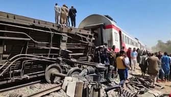 This screengrab provided by AFPTV ahows people gathered around the wreckage of two trains that collided in the Tahta district of Sohag province, some 460 kms (285 miles) south of the Egyptian capital Cairo, reportedly killing at least 32 people and injuring scores of others, on March 26, 2021. - Egypt has been plagued with deadly train accidents in recent years that have been widely blamed on inadequate infrastructure and poor maintenance. (Photo by - / AFP) (Photo by -/AFP via Getty Images)