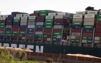 epa09100517 A view of the Ever Given container ship in the Suez Canal, Egypt, 27 March 2021. The container ship Ever Given ran aground in the Suez Canal on 23 March, blocking passage of other ships and causing a traffic jam for cargo vessels. The head of the Suez Canal Authority announced that 'the navigation through the Suez Canal is temporarily suspended' until the floatation of the Ever Given is completed.  EPA/KHALED ELFIQI