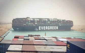 epa09092812 The Suez Canal is blocked by a large container ship in Cairo, Egypt, 24 March 2021 A large container ship registered in Panama ran aground in the Suez Canal on 23 March, blocking passage of other ships and causing a traffic jam for cargo vessels.  EPA/STR