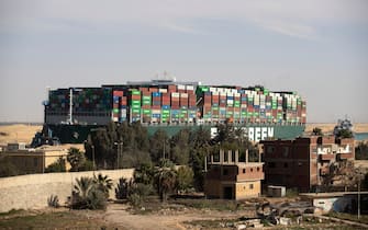 SUEZ, EGYPT - MARCH 29: The container ship, the Ever Given, is seen moving at the Suez Canal on March 29, 2021 in Suez, Egypt. Early Monday, the Suez Canal Authority said the angle of the Ever Given, a huge container ship stuck in the canal, had been corrected by 80 percent. The ship ran aground in the canal last Tuesday, after being caught in 40-knot winds. The Suez Canal is one of the worlds busiest shipping lanes and the blockage has created a backlog of vessels at either end, raising concerns over the impact the accident will have on global shipping and supply chains. (Photo by Mahmoud Khaled/Getty Images)