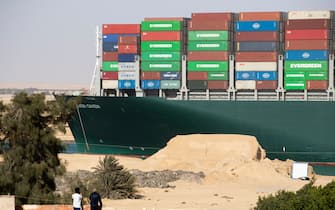 SUEZ, EGYPT - MARCH 29: The container ship, the Ever Given, is seen moving at the Suez Canal on March 29, 2021 in Suez, Egypt. Early Monday, the Suez Canal Authority said the angle of the Ever Given, a huge container ship stuck in the canal, had been corrected by 80 percent. The ship ran aground in the canal last Tuesday, after being caught in 40-knot winds. The Suez Canal is one of the worlds busiest shipping lanes and the blockage has created a backlog of vessels at either end, raising concerns over the impact the accident will have on global shipping and supply chains. (Photo by Mahmoud Khaled/Getty Images)