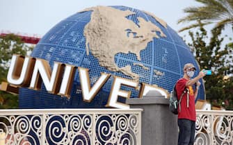 A visitor takes a selfie at Universal Studios theme park on the first day of reopening from the coronavirus pandemic, on June 5, 2020, in Orlando, Florida. (Photo by Gregg Newton / AFP) (Photo by GREGG NEWTON/AFP via Getty Images)