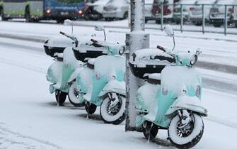 epa09117861 A view of snow-covered scooters in Olsztyn, northeastern Poland, 06 April 2021. The Polish Institute of Meteorology and Water Management (IMGW) is forecasting continuing cold temperatures and snowfall in the next days.  EPA/Tomasz Waszczuk POLAND OUT