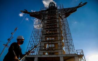 A worker is seen in front of a Christ statue being built in Encantado, Rio Grande do Sul state, Brazil, on April 09, 2021. - The Christ the Protector statue under construction in Encantado will be larger than Rio de Janeiro's Christ the Redeemer and the third-largest in the world. (Photo by SILVIO AVILA / AFP) (Photo by SILVIO AVILA/AFP via Getty Images)