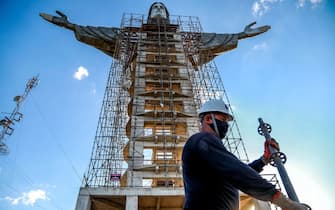 A worker is seen in front of a Christ statue being built in Encantado, Rio Grande do Sul state, Brazil, on April 09, 2021. - The Christ the Protector statue under construction in Encantado will be larger than Rio de Janeiro's Christ the Redeemer and the third-largest in the world. (Photo by SILVIO AVILA / AFP) (Photo by SILVIO AVILA/AFP via Getty Images)