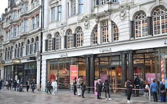 CARDIFF, WALES - APRIL 12: Shoppers queue outside TK Maxx as non-essential retail reopens on April 12, 2021 in Cardiff, Wales. Lockdown restrictions have been eased further today with non-essential retail reopening in England and Wales after remaining closed for three months during the latest Covid-19 lockdown. In England outdoor hospitality will reopen today and in Wales from April 26. (Photo by Matthew Horwood/Getty Images)