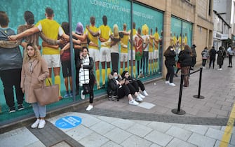 CARDIFF, WALES - APRIL 12: Shoppers queue outside Primark from 7am as non-essential retail reopens on April 12, 2021 in Cardiff, Wales. Lockdown restrictions have been eased further today with non-essential retail reopening in England and Wales after remaining closed for three months during the latest Covid-19 lockdown. In England outdoor hospitality will reopen today and in Wales from April 26. (Photo by Matthew Horwood/Getty Images)