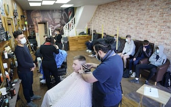 People get their hair cut at the Unique Traditional barber's in Whitley Bay, as England takes another step back towards normality with the further easing of lockdown restrictions. Picture date: Monday April 12, 2021. (Photo by Owen Humphreys/PA Images via Getty Images)