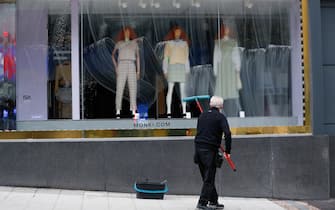 A worker cleans the windows at the Monki clothing store ahead of its reopening in Birmingham, U.K., on Monday, April 12, 2021. Non-essential retailers as well as pubs and restaurants with outdoor space will reopen Monday across England after almost 100 days of lockdown, hoping pent-up demand will translate into strong sales. Photographer: Darren Staples/Bloomberg via Getty Images