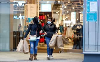 Customers leave a Primark clothing store, with shopping bags, following its reopening in Birmingham, U.K., on Monday, April 12, 2021. Non-essential retailers as well as pubs and restaurants with outdoor space will reopen Monday across England after almost 100 days of lockdown, hoping pent-up demand will translate into strong sales. Photographer: Darren Staples/Bloomberg via Getty Images