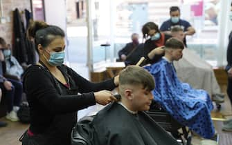 People get their hair cut at the Unique Traditional barber's in Whitley Bay, as England takes another step back towards normality with the further easing of lockdown restrictions. Picture date: Monday April 12, 2021. (Photo by Owen Humphreys/PA Images via Getty Images)