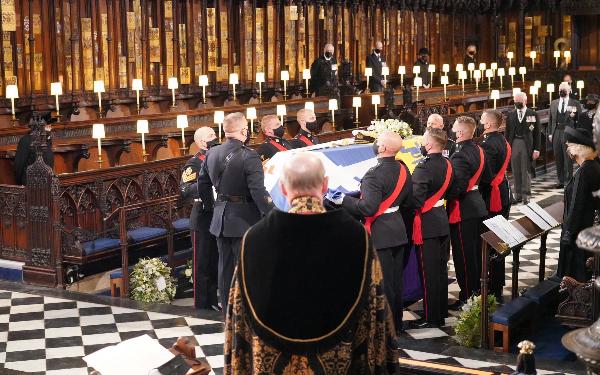 Queen Elizabeth II (left) watches as pall bearers carry the coffin of the Duke of Edinburgh during his funeral at St George's Chapel, Windsor Castle, Berkshire. Picture date: Saturday April 17, 2021.