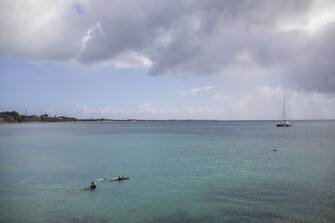 1232039006 People snorkel in the water in Saint Croix, Virgin Islands, U.S., on Sunday, March 28, 2021. Across the Caribbean, the impact of COVID-19 on the travel and tourism industry has been very apparent, the Caribbean Tourism Organization (CTO) said in a report. 2020 saw a 65.5 percent drop in tourist arrivals to the Caribbean. Photographer: Ivan Valencia/Bloomberg via Getty Images