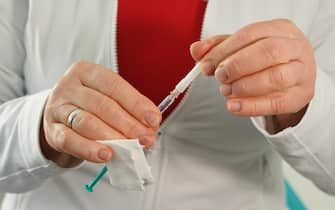 epa09048639   A doctor holds a syringe filled with a dose of the AstraZeneca vaccine against COVID-19 while inoculating patients at her private practice as part of a pilot project in the state of Brandenburg during the coronavirus pandemic in Senftenberg, Germany, 03 March 2021. Several German states are allowing vaccinations against COVID-19 to begin in a limited number of private medical practices with the aim of expanding venues that offer the vaccines beyond the current mass vaccination centers. While Germany's vaccination rollout has been hampered by less than anticipated shipments of vaccine, the volume of shipments has begun increasing, leading to higher weekly numbers of vaccinations.  EPA/Sean Gallup / POOL