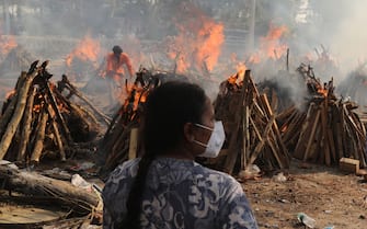 A family member looks on as several funeral pyres of those patients who died of COVID-19 disease burn up during the mass cremation at Ghazipur cremation ground in New Delhi.
In India the highest single-day spike in coronavirus infection. The report recorded 352,991 new Covid-19 cases and 2,812 deaths in the last 24 hours amid an oxygen crisis. - Naveen Sharma / SOPA Images//SOPAIMAGES_08380023/2104270905/Credit:SOPA Images/SIPA/2104270907