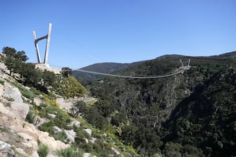 epa09164740 A view of '516 Arouca', considered the largest pedestrian suspension bridge in the world, at 516 meters long and 175 meters high, in Arouca, Portugal, 16 April 2021 (issued 28 April 2021). The bridge is secured by steel cables arranged 175 meters above the Paiva riverbed and can be visited by the general public from 03 May.  EPA/ESTELA SILVA