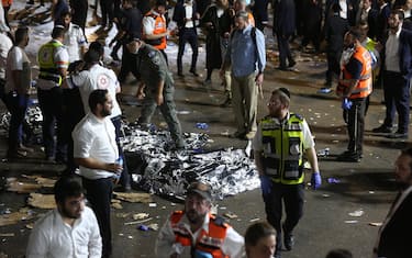 epa09168831 Israeli security officials and rescuers inspect the dead bodies of dozens of Ultra-Orthodox Jews who died during an event at a revelry complex during Lag Ba'Omer; in Mount Meron, Israel, 29 April 2021. Dozens of people were killed and injured in the revelry complex on Mount Meron, after an apparent stampede occured during an event marking the end of the Jewish holiday of Lag Ba'Omer, the day marks the anniversary of the death of Rabbi Shimon bar Yochai, a sage from some 1,800 years ago, and the day on which he revealed the secrets of the 'kabbalah,' or Jewish mysticism. EPA/DAVID COHEN ISRAEL OUT
