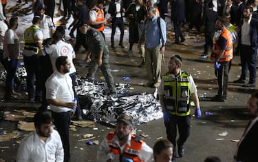 epa09168831 Israeli security officials and rescuers inspect the dead bodies of dozens of Ultra-Orthodox Jews who died during an event at a revelry complex during Lag Ba'Omer; in Mount Meron, Israel, 29 April 2021. Dozens of people were killed and injured in the revelry complex on Mount Meron, after an apparent stampede occured during an event marking the end of the Jewish holiday of Lag Ba'Omer, the day marks the anniversary of the death of Rabbi Shimon bar Yochai, a sage from some 1,800 years ago, and the day on which he revealed the secrets of the 'kabbalah,' or Jewish mysticism.  EPA/DAVID COHEN ISRAEL OUT