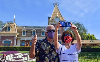 Anaheim, CA - April 30: John and Vickie Macon take a selfie in front of Disneyland Railroad - Main Street Station in Anaheim, CA, on Friday, April 30, 2021. The resort"u2019s parks have been closed for 412 days due to the COVID-19 outbreak. (Photo by Jeff Gritchen/MediaNews Group/Orange County Register via Getty Images)