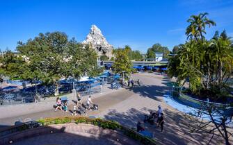 Anaheim, CA - April 30: Visitors roam Tomorrowland around 9 A.M. at Disneyland in Anaheim, CA, on Friday, April 30, 2021. The resort"u2019s parks have been closed for 412 days due to the COVID-19 outbreak. (Photo by Jeff Gritchen/MediaNews Group/Orange County Register via Getty Images)