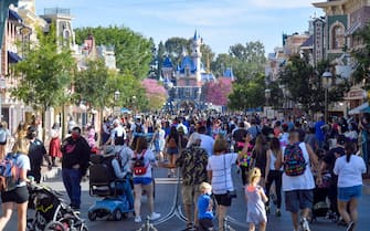 Anaheim, CA - April 30: Visitors to Disneyland walk up Main Street U.S.A. just after the gates opened in Anaheim, CA, on Friday, April 30, 2021. The resort"u2019s parks have been closed for 412 days due to the COVID-19 outbreak. (Photo by Jeff Gritchen/MediaNews Group/Orange County Register via Getty Images)