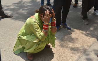 epa09167217 Family members of COVID-19 victims react outside the hospital mortuary in New Delhi, India, 29 April 2021. Delhi reported 25,986 fresh cases, 368 deaths in last 24 hours and continue to struggle with the oxygen supply.  EPA/IDREES MOHAMMED