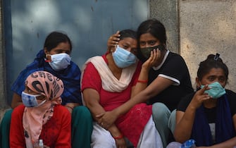 epa09167949 Grieving family members of COVID-19 victims at a cremation ground in New Delhi, India, 29 April 2021. Delhi reported 25,986 fresh cases, 368 deaths in last 24 hours and continue to struggle with the oxygen supply.  EPA/IDREES MOHAMMED