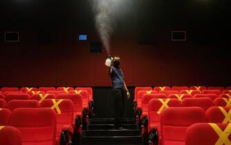 A cinema worker sprays disinfectant into the audience seats.
One of the sectors most affected by the Covid-19 pandemic is the film sector and after a few months of not operating, theatres can now reopen under standard health protocols in their operations. (Photo by Andry Denisah / SOPA Images/Sipa USA)