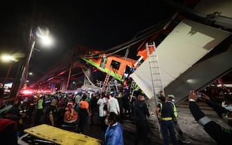 MEXICO CITY, MEXICO - MAY 03: Emergency personnel work to search for accident survivors after a raised subway track collapsed on May 03, 2021 in Mexico City, Mexico. The Line 12 accident happened between Olivos and Tezonco Metro stations. (Photo by Hector Vivas/Getty Images)