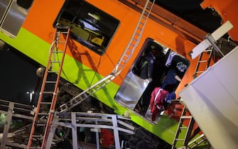 MEXICO CITY, MEXICO - MAY 03: Emergency personnel search for accident survivors after a raised subway track collapsed on May 03, 2021 in Mexico City, Mexico. The Line 12 accident happened between Olivos and Tezonco Metro stations. (Photo by Hector Vivas/Getty Images)