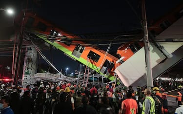MEXICO CITY, MEXICO - MAY 03: Emergency personnel work to search for accident survivors after a raised subway track collapsed on May 03, 2021 in Mexico City, Mexico. The Line 12 accident happened between Olivos and Tezonco Metro stations. (Photo by Hector Vivas/Getty Images)