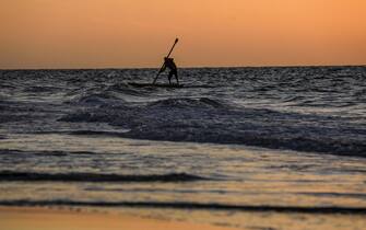 epa09008141 A Palestinian fisherman goes fishing at sea during sunset in Gaza City, 12 February 2021.  EPA/MOHAMMED SABER