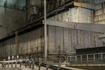 PRIPYAT, UKRAINE - JULY 2: Workers inside the 'New Safe Confinement' which contains the old sarcophagus entombing the destroyed reactor number four at the Chernobyl Nuclear Power Plant on July 2, 2019 in Pripyat, Ukraine. In November 2016, the 'New Safe Confinement' structure was shifted into place to prevent the decaying reactor from further contaminating the environment and eventually allow its dismantling; the Ukrainian government will soon be taking control of the new confinement structure. The power station's reactor number four exploded in April 1986, showering radiation over the local area, nearby regions of Belarus, and other portions of Europe. (Photo by Brendan Hoffman/Getty Images)