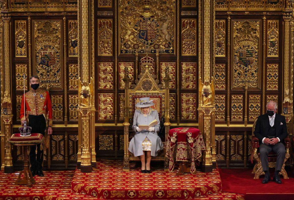 Britain's Queen Elizabeth II reads the Queen's Speech on the The Sovereign's Throne, as Britain's Prince Charles, Prince of Wales (R) listens, in the House of Lords chamber, during the State Opening of Parliament at the Houses of Parliament in London on May 11, 2021, which is taking place with a reduced capacity due to Covid-19 restrictions. - The State Opening of Parliament is where Queen Elizabeth II performs her ceremonial duty of informing parliament about the government's agenda for the coming year in a Queen's Speech. (Photo by Chris Jackson / POOL / AFP) (Photo by CHRIS JACKSON/POOL/AFP via Getty Images)