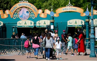 PARIS, FRANCE - JULY 13: People with annual passes wearing protective face masks arrive to visit Disneyland Paris on July 13, 2020 in Marne-la-Vallee, near Paris, France. After four months of closure, the amusement park officially reopens its doors on Wednesday July 15 with compulsory reservations online. The Disneyland Paris and Walt Disney studio parks have been closed since mid-March due to the coronavirus epidemic (COVID 19). (Photo by Chesnot/Getty Images)