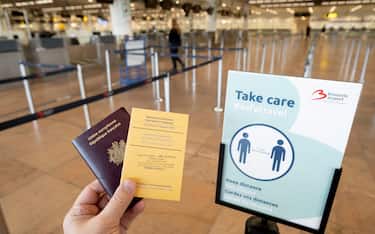 ZAVENTEM, FLEMISH REGION, BELGIUM - FEBRUARY 26 : In this photo illustration, a French passport and an International Certificate of Vaccination or Prophylaxis are shown in the nearly empty Brussels Zaventem National Airport on February 126 2021 in Brussels, Belgium. The number of daily deaths from the coronavirus is still in sharp decline, according to the latest data released by the Sciensano Public Health Institute on Thursday morning. On average, 30.3 people died of Covid-19 between February 15 and 21, a decrease of 24.3% in one week. In total, the epidemic claimed the lives of 21,988 people in Belgium. (Photo by Thierry Monasse/Getty Images)