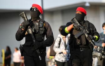 epa09224588 Armed men provide security for protesters as they march through the streets to commemorate the anniversary of George Floyd's death in Minneapolis, Minnesota, USA, 23 May 2021. The rally and march is part of several days of events to mark the one year anniversary of FloydÕs death that sparked the Black Lives Matter movement around the world.  EPA/CRAIG LASSIG