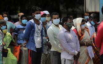 epa09206286 Fever patients wearing face protective masks wait without maintaining social distance for a test for COVID-19 at a test center during coronavirus pandemic crisis in Kalyani near Kolkata, eastern India, 17 May 2021.State Government imposed a new partial lockdown order to combat coronavirus pandemic in Kolkata. According to the Indian Ministry of Health, India recorded 311,000 fresh Covid-19 cases in the last 24 hours.  EPA/PIYAL ADHIKARY